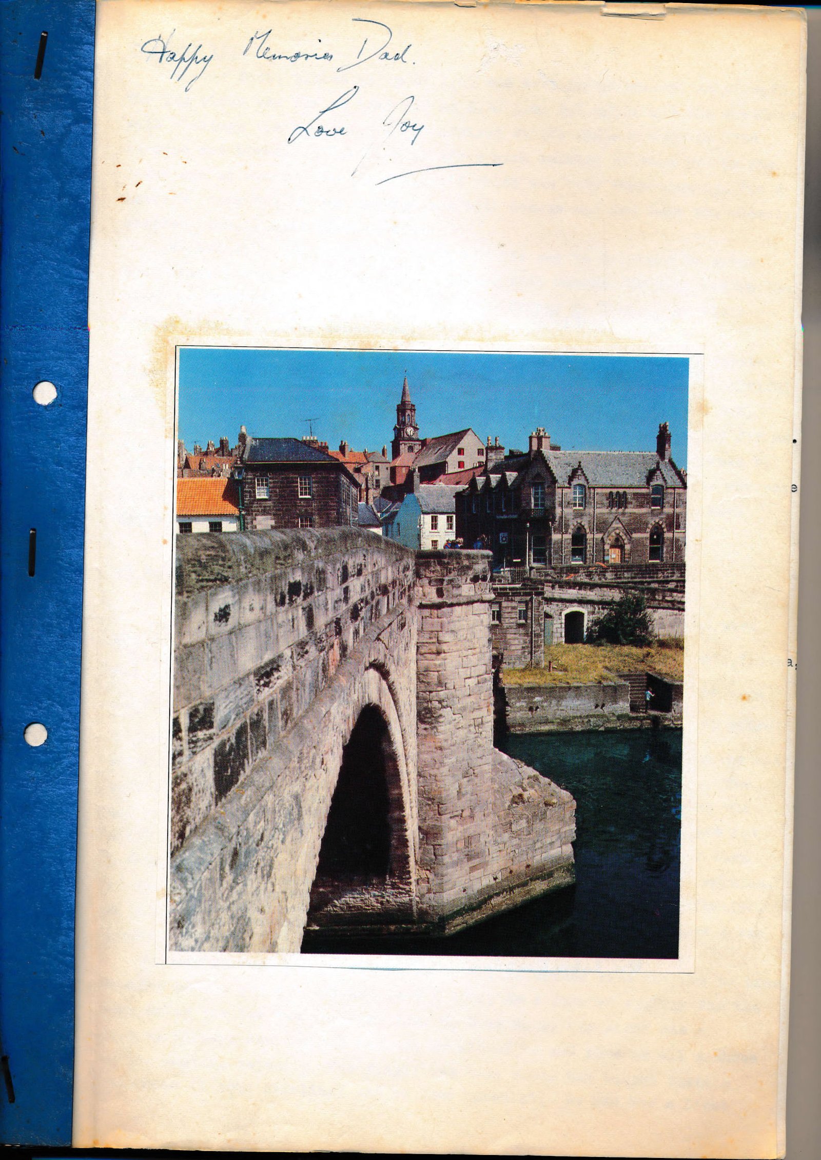 Scrapbook page inscribed 'Happy Memories Dad. Love Joy' with a photograph of a stone bridge in a Scottish border town