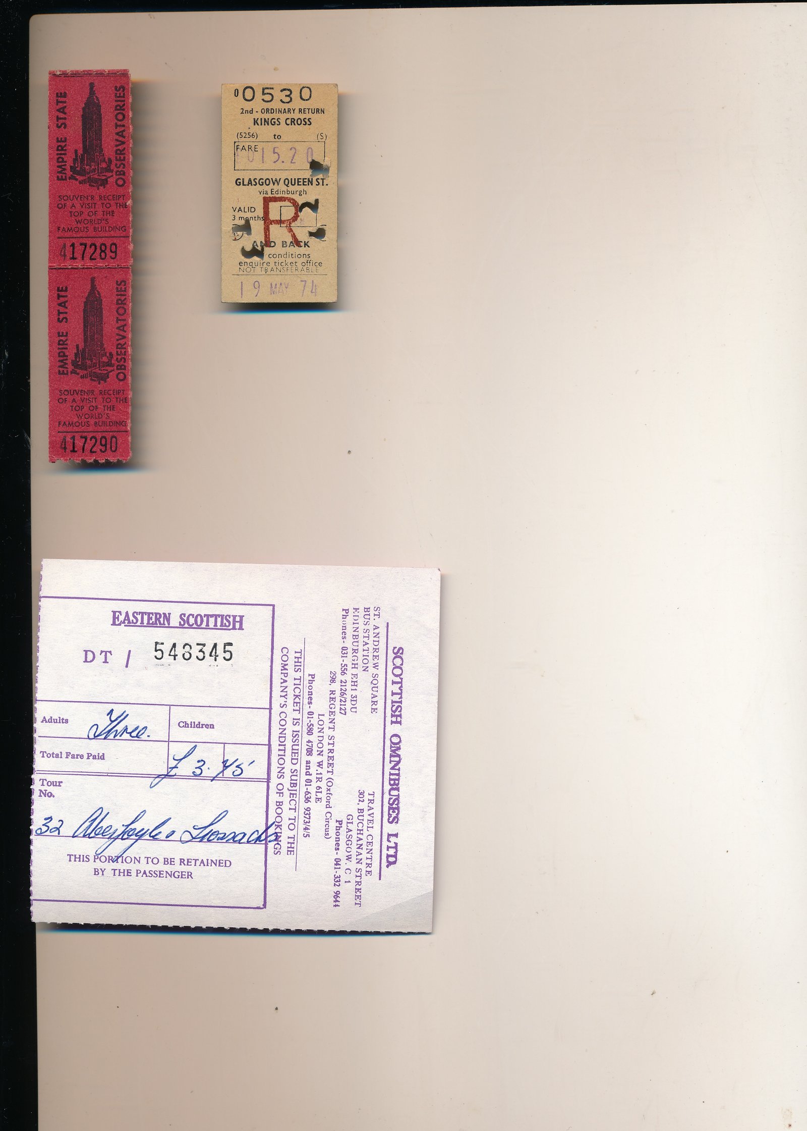Travel tickets and documents mounted on a page: railway tickets, bus ticket stubs, and handwritten annotations